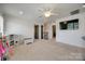 Neutral carpeted bonus room with closet, ceiling fan, television, and adjacent hallway at 4032 Wild Turkey Ln, Indian Land, SC 29707