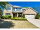 Charming two-story home featuring brick and vinyl siding, lush landscaping, and a welcoming two-car garage at 4032 Wild Turkey Ln, Indian Land, SC 29707
