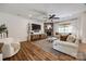 Cozy living room with stone fireplace, ceiling fan, and comfortable seating area at 4032 Wild Turkey Ln, Indian Land, SC 29707