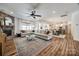 Open-concept living space with a stone fireplace, large sectional, and seamless flow to the dining area at 4032 Wild Turkey Ln, Indian Land, SC 29707