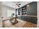 Spacious home office featuring custom built-in shelving and a large window for natural light at 4032 Wild Turkey Ln, Indian Land, SC 29707