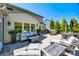 Expansive patio featuring outdoor kitchen, dining set, seating, string lights, and lush landscaping at 4032 Wild Turkey Ln, Indian Land, SC 29707