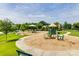 Community playground with various play structures, including slides, a seesaw, and shaded seating areas at 4032 Wild Turkey Ln, Indian Land, SC 29707
