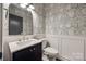 Chic powder room featuring patterned wallpaper, modern fixtures, and elegant wainscoting at 4032 Wild Turkey Ln, Indian Land, SC 29707