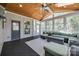 Enclosed sunroom features wood ceiling, backyard view, and wicker furniture at 4032 Wild Turkey Ln, Indian Land, SC 29707