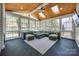 Enclosed sunroom features wood ceiling and ample windows showcasing natural light and backyard at 4032 Wild Turkey Ln, Indian Land, SC 29707