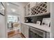 Elegant wine room features custom cabinetry, a wine fridge, and stylish decor at 4032 Wild Turkey Ln, Indian Land, SC 29707