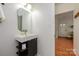 Modern powder room with floating vanity and sink, and a view to other rooms in the home at 4133 Carl Parmer Dr, Harrisburg, NC 28075
