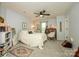 Cozy bedroom featuring neutral carpet, ceiling fan, and coordinated decor at 4133 Carl Parmer Dr, Harrisburg, NC 28075