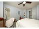Bedroom with neutral carpet, ceiling fan, white chair and multiple doorways to other rooms at 4133 Carl Parmer Dr, Harrisburg, NC 28075
