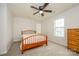 Bedroom with neutral walls, carpet, ceiling fan, and natural light through large windows at 4133 Carl Parmer Dr, Harrisburg, NC 28075