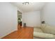 Bright bedroom with hardwood floors, comfortable sofa, and view to other rooms in the home at 4133 Carl Parmer Dr, Harrisburg, NC 28075