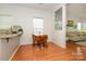 Bright kitchen nook with open space and connection to living area, featuring hardwood floors and neutral decor at 4133 Carl Parmer Dr, Harrisburg, NC 28075