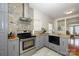 Renovated kitchen featuring stainless steel appliances, stone countertops, gray cabinets and modern vent hood at 4133 Carl Parmer Dr, Harrisburg, NC 28075