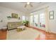 Open living room featuring hardwood floors, neutral walls, and French doors to a patio, creating a welcoming atmosphere at 4133 Carl Parmer Dr, Harrisburg, NC 28075