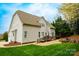 Expansive backyard with a charming brick patio, deck, hot tub, fire pit, and lush lawn at 4205 Green Park Ct, Harrisburg, NC 28075