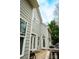 Rear view of home with a wood deck with steps down to the patio and hot tub at 4205 Green Park Ct, Harrisburg, NC 28075