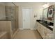 Bathroom featuring tiled flooring, double sinks, and a glass-enclosed shower with multiple shower heads at 4205 Green Park Ct, Harrisburg, NC 28075