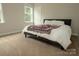 Bedroom featuring a bed with a decorative blanket and a sunlit window at 4205 Green Park Ct, Harrisburg, NC 28075