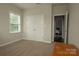 Neutral bedroom featuring carpet, double closets, and a view to another room at 4205 Green Park Ct, Harrisburg, NC 28075