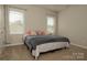 Bedroom featuring two windows and neutral paint, creating a serene living space at 4205 Green Park Ct, Harrisburg, NC 28075