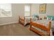 Bedroom featuring two twin beds with patterned bedding and two windows at 4205 Green Park Ct, Harrisburg, NC 28075