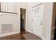 Inviting entryway featuring dark hardwood floors, a white door, and a view of the stairs at 4205 Green Park Ct, Harrisburg, NC 28075