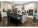 Bright kitchen featuring an island with bar stools and modern appliances at 4205 Green Park Ct, Harrisburg, NC 28075