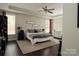 Calm main bedroom with tray ceiling, hardwood floors, and neutral decor at 4205 Green Park Ct, Harrisburg, NC 28075