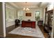 Elegant home office featuring dark wood floors, wainscoting, chandelier, and a large desk at 4205 Green Park Ct, Harrisburg, NC 28075