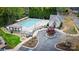 Aerial view of a community pool, featuring lounge chairs, shaded area, and clubhouse at 4205 Green Park Ct, Harrisburg, NC 28075