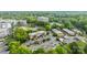 Overhead view displaying apartments surrounded by greenery and a parking lot, complete with a refreshing community pool at 4754 Hedgemore Dr # O, Charlotte, NC 28209