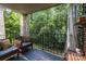 Relaxing on the balcony, enjoy the view of the surrounding greenery from comfortable seating at 4754 Hedgemore Dr # O, Charlotte, NC 28209