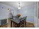 A dining area featuring modern decor and a view into the adjacent kitchen at 4754 Hedgemore Dr # O, Charlotte, NC 28209