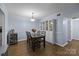 Well-lit dining room with a modern table, seating for four, and a stylish display cabinet at 4754 Hedgemore Dr # O, Charlotte, NC 28209