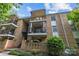 A brick apartment building featuring multiple balconies, an entry stairwell, and green landscaping at 4754 Hedgemore Dr # O, Charlotte, NC 28209