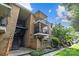 A brick apartment building featuring multiple balconies, an entry stairwell, and green landscaping at 4754 Hedgemore Dr # O, Charlotte, NC 28209