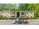 Brick apartment building featuring multiple balconies, a green roof, and ample parking spaces at 4754 Hedgemore Dr # O, Charlotte, NC 28209