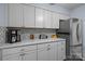 Updated kitchen features gray cabinets, quartz countertops, and mosaic tile backsplash at 4754 Hedgemore Dr # O, Charlotte, NC 28209