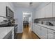 Updated kitchen featuring white cabinets, modern appliances, and an open view to the dining area at 4754 Hedgemore Dr # O, Charlotte, NC 28209