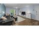 A cozy living room with wood floors, modern furniture, and a sliding glass door to the balcony at 4754 Hedgemore Dr # O, Charlotte, NC 28209