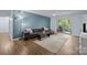 Inviting living room featuring a plush black leather sectional sofa and sliding glass doors to the patio at 4754 Hedgemore Dr # O, Charlotte, NC 28209