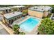 An aerial view of the community pool, lined with lounge chairs and surrounded by well-maintained landscaping at 4754 Hedgemore Dr # O, Charlotte, NC 28209
