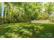 Expansive, lush backyard featuring mature trees and well-maintained lawn at 510 N Jackson Rd, Lancaster, SC 29720