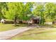 A cozy brick house with an attached carport and a driveway, shaded by a mature tree at 510 N Jackson Rd, Lancaster, SC 29720
