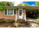 Inviting brick home entrance with a covered carport, white trim, and well-kept landscaping at 510 N Jackson Rd, Lancaster, SC 29720