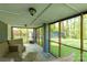 Relaxing screened porch with outdoor furniture overlooks the spacious backyard and adjacent shed at 510 N Jackson Rd, Lancaster, SC 29720