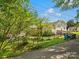 Spacious backyard with a black metal fence, offering both privacy and an inviting outdoor space with mature trees at 512 Secrest Ave, Belmont, NC 28012