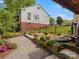 Beautiful home featuring a landscaped garden with elevated flower beds in the backyard at 512 Secrest Ave, Belmont, NC 28012