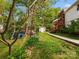 Inviting backyard featuring lush greenery, stone path, and a screened porch, offering a serene outdoor space at 512 Secrest Ave, Belmont, NC 28012